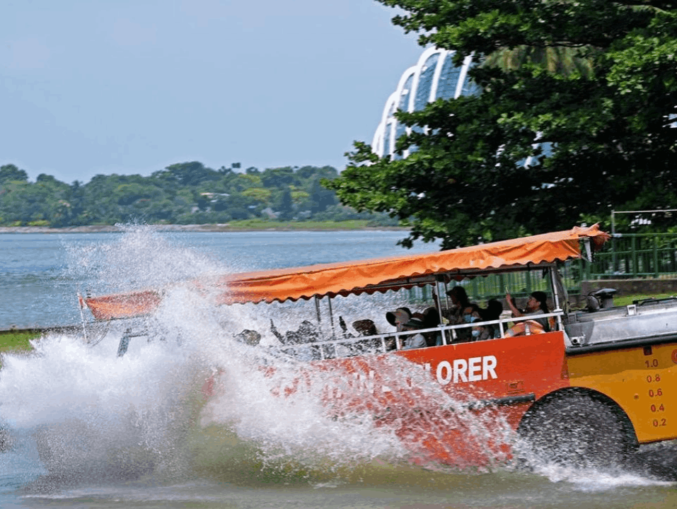 Captain Explorer DUKW amphibious tour splashing into the water during a Singapore sightseeing experience.