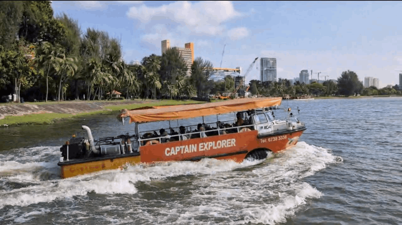 Families enjoying the Captain Explorer DUKW Tour as the amphibious vehicle cruises on the water in Singapore.