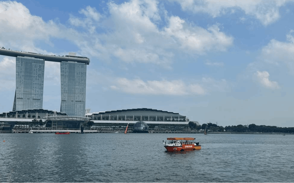 Captain Explorer DUKW tour boat cruising across Marina Bay with Marina Bay Sands and the Singapore skyline in the background.