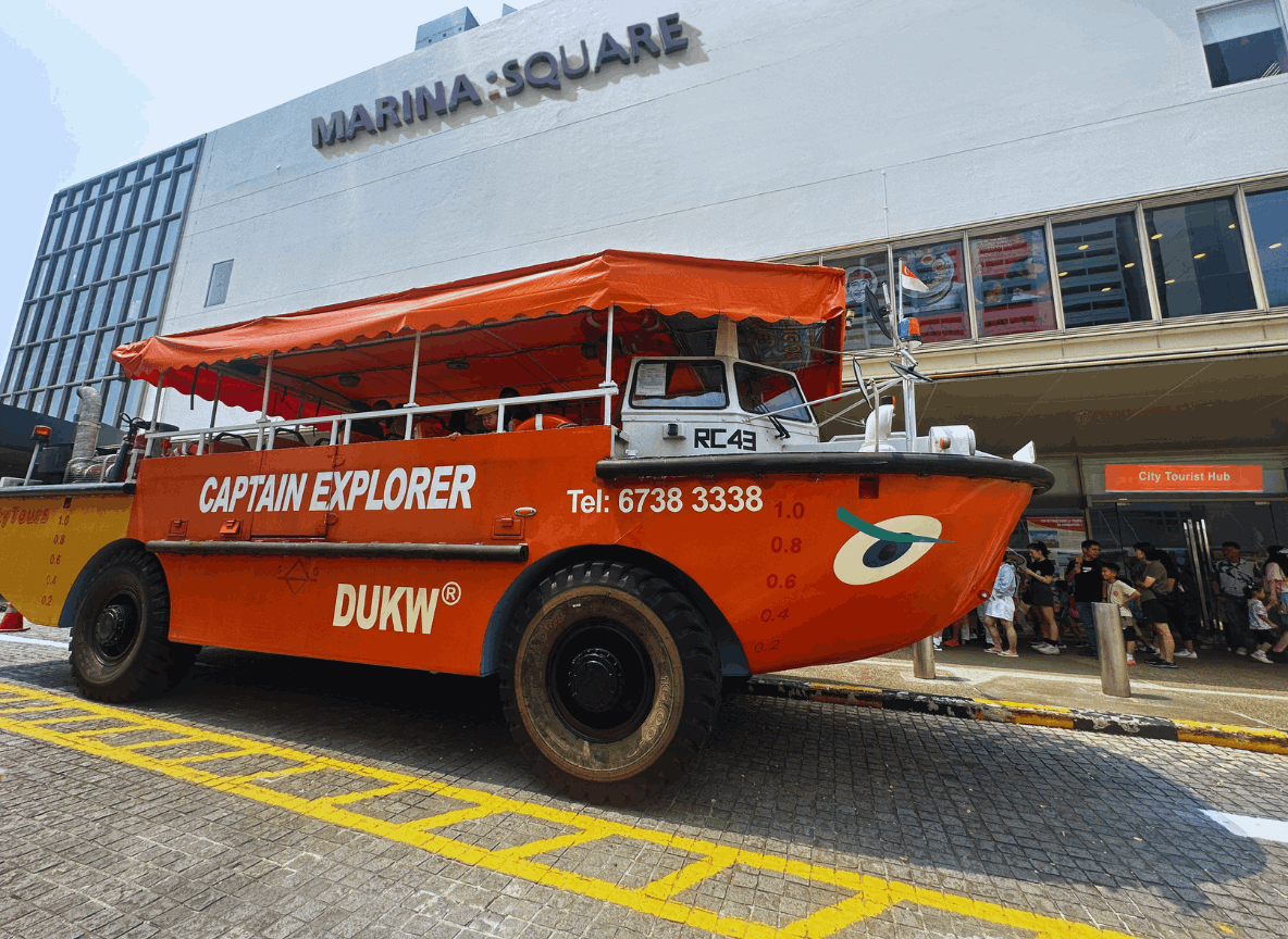  The exterior storefront of the City Tourist Hub in Singapore, showing the entrance with tourists in queue for the popular Captain Explorer DUKW Tour.