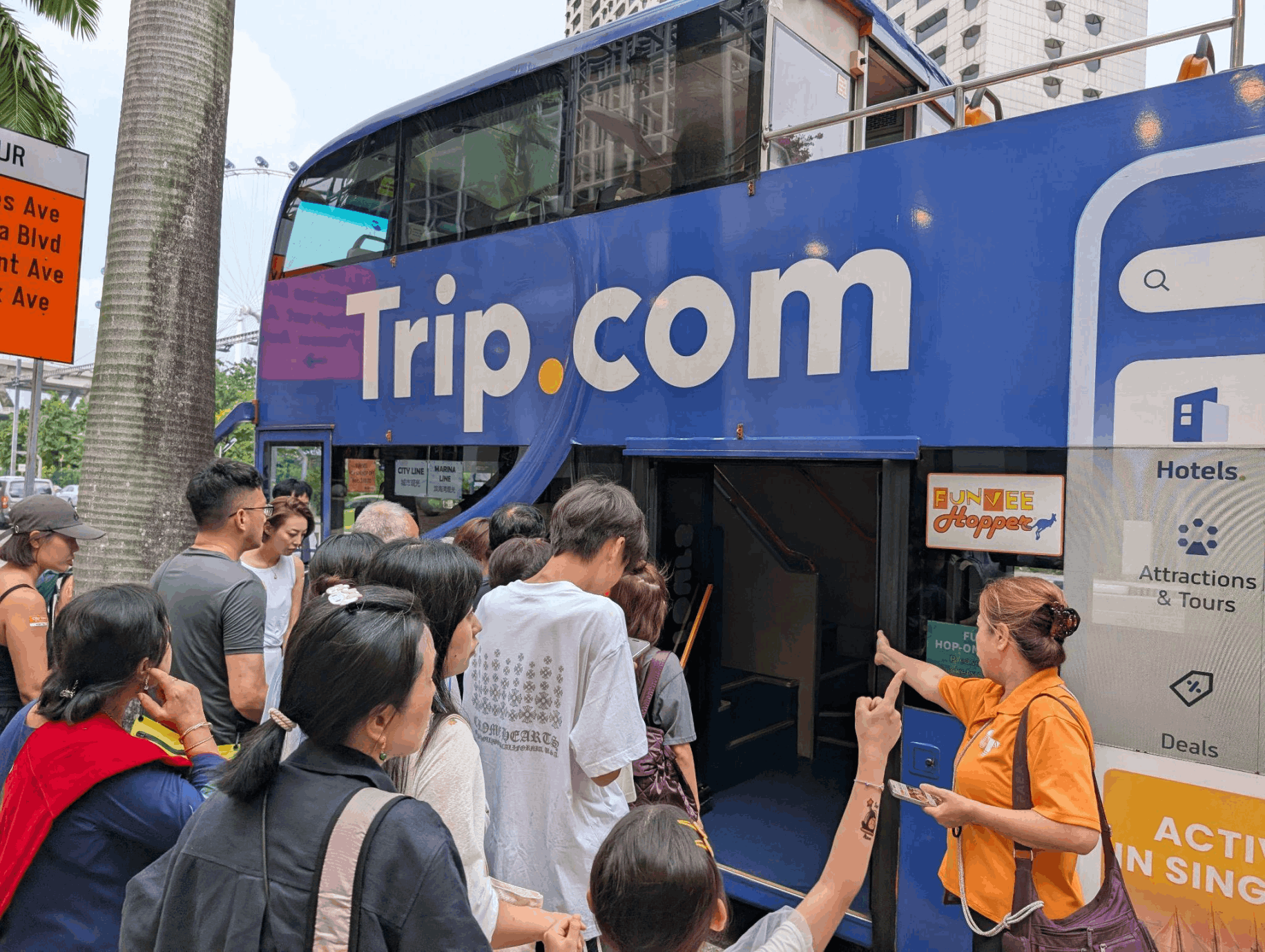 Families and tourists boarding a FunVee Hop-On Hop-Off Bus for sightseeing in Singapore.