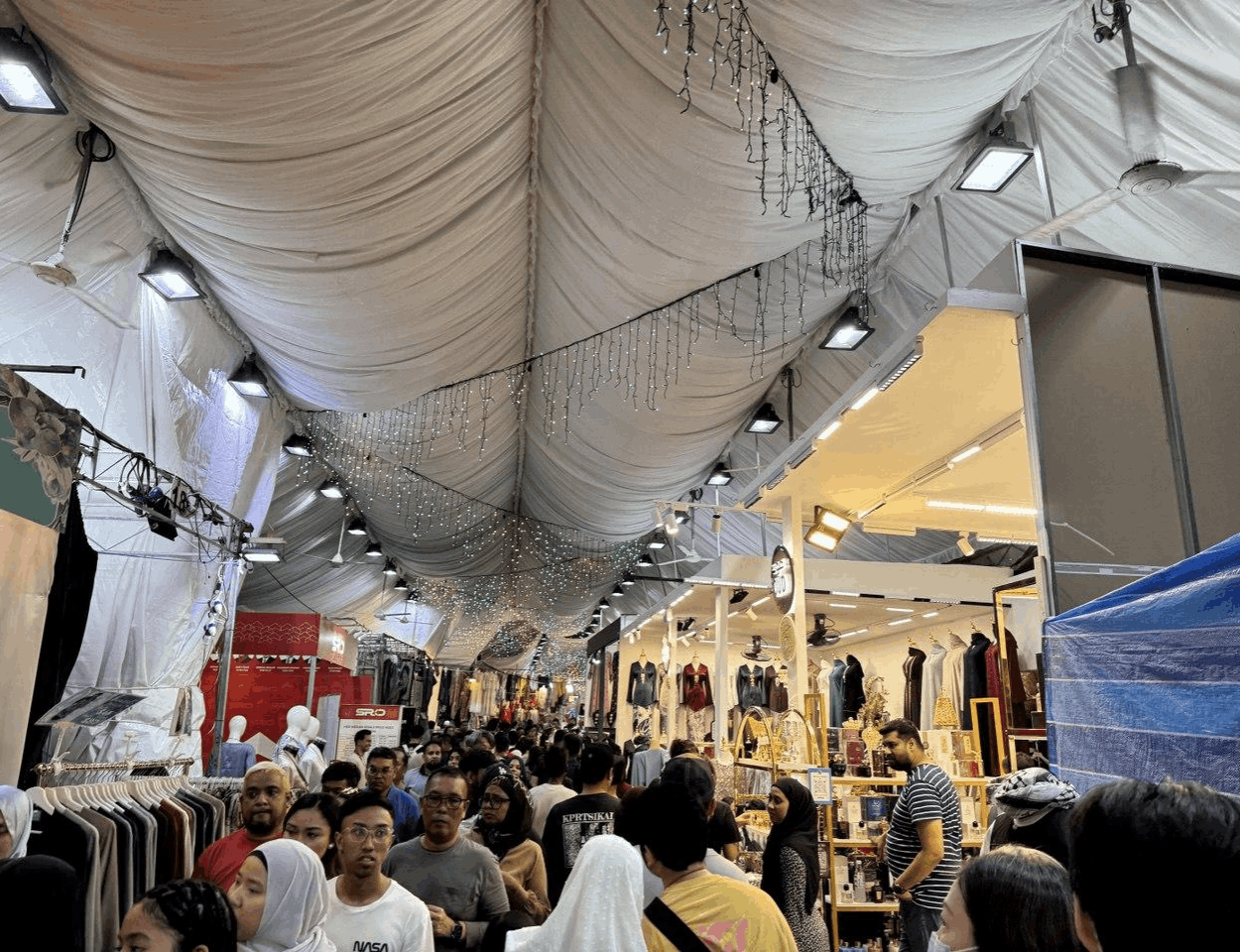 Crowds shopping and browsing food and retail stalls inside the sheltered Geylang Serai Ramadan Bazaar in Singapore during March.