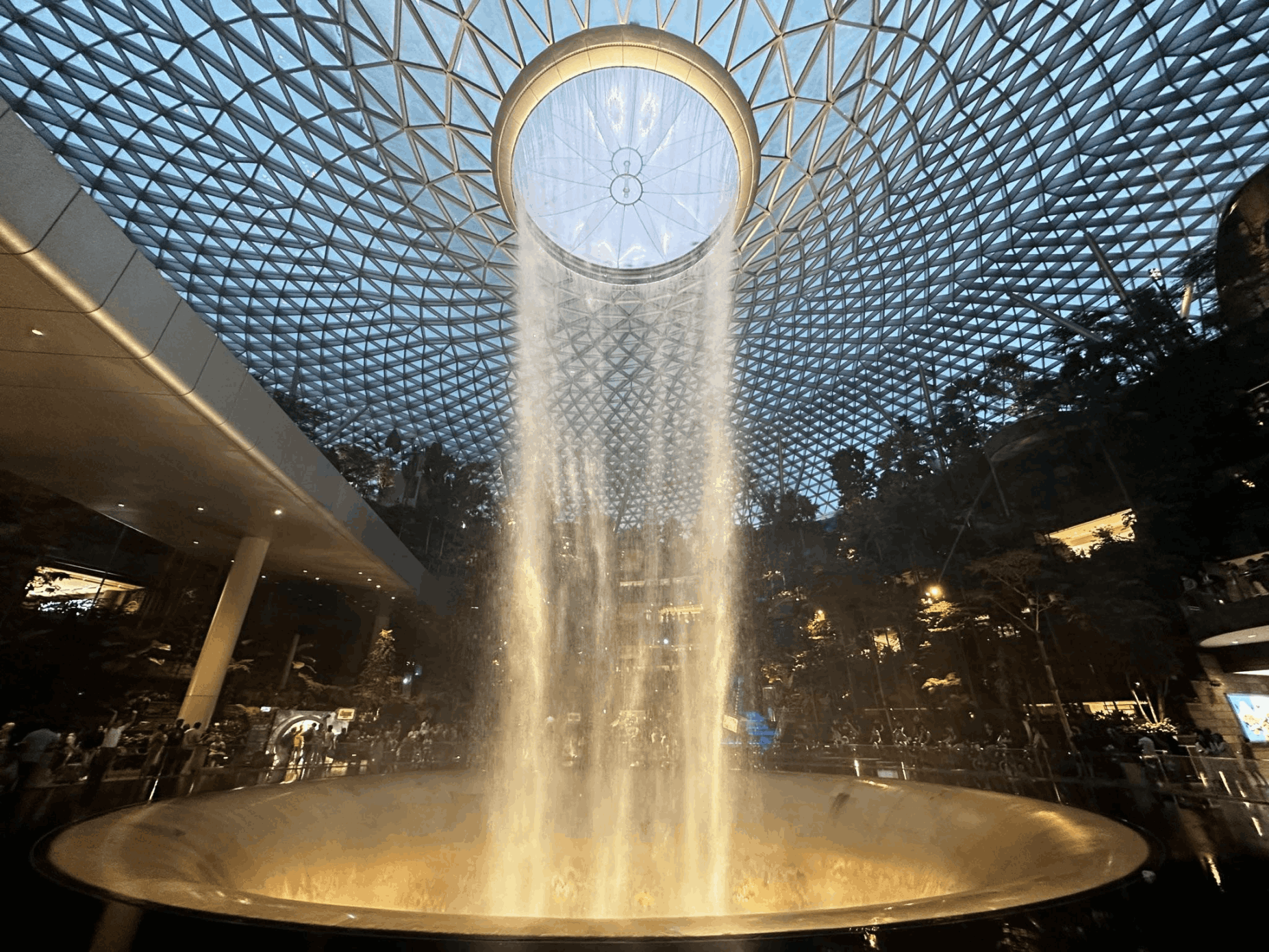 Rain Vortex and Canopy Bridge at Jewel Changi Airport, a popular stopover attraction for travellers visiting Singapore during a layover.