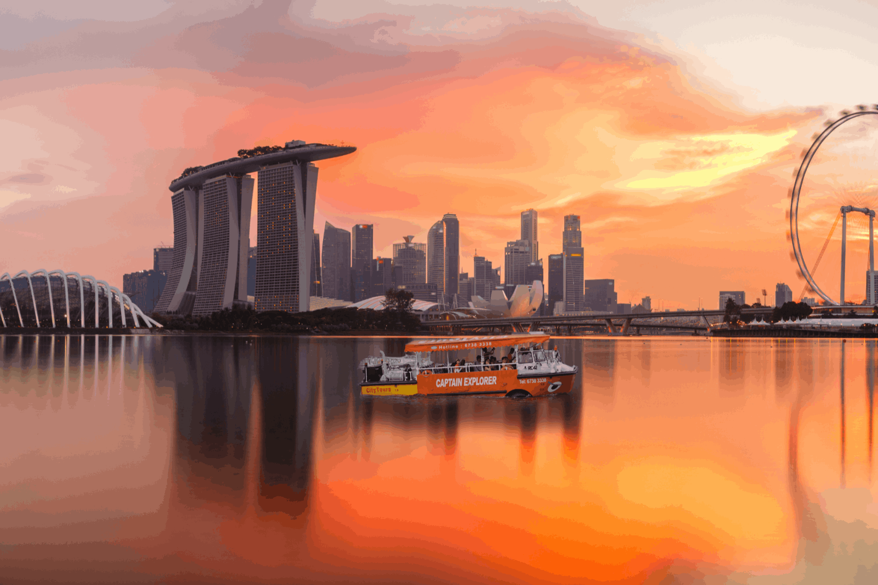 Singapore Sunset Cruise by the Bay with Marina Bay Sands, Singapore Flyer and city skyline views during golden hour.