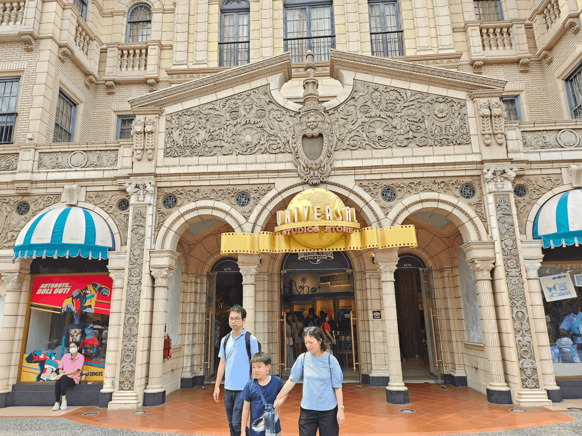 Family walking outside the Universal Studios Store at Resorts World Sentosa in Singapore.